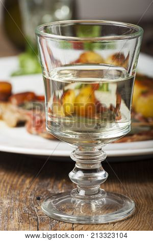 white wine in a glass an saltimbocca