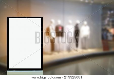 vertical advertising billboard or blank showcase light box for your text message or media content in front of men fashion clothes shop showcase in shopping mall sale commercial and marketing