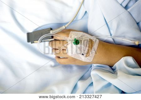 Spo2 Sensor (peripheral Capillary Oxygen Saturation) And Iv Drip On Patient Hands At The Hospital Ro