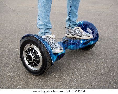 Voronezh, Russia - August 12, 2017: The feet of a man stand on the hoverboard site