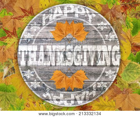 Happy Thanksgiving written on wood with clorfull leaf background