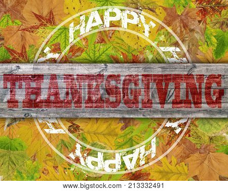 Happy Thanksgiving written on wood with clorfull leaf background