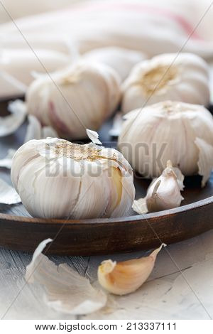 Garlic, Cloves And Peel On A Wooden Dish.