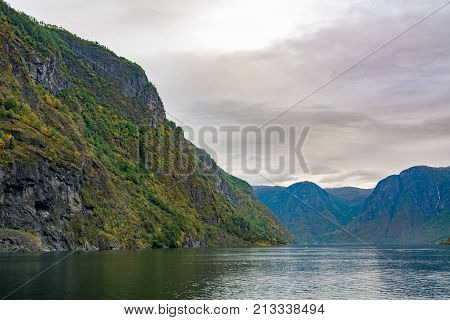 Flam is a village in Flamsdalen at the inner end of the Aurlandsfjorden a branch of Sognefjorden. The village is located in the municipality of Aurland in Sogn og Fjordane county Norway.