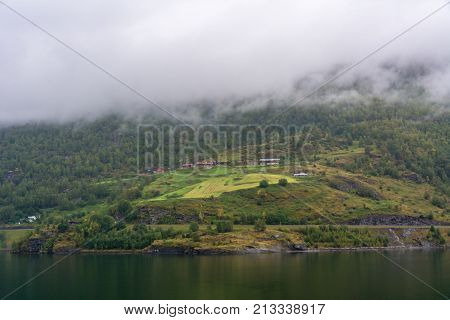 Flam is a village in Flamsdalen at the inner end of the Aurlandsfjorden a branch of Sognefjorden. The village is located in the municipality of Aurland in Sogn og Fjordane county Norway.