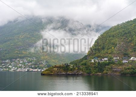 Flam is a village in Flamsdalen at the inner end of the Aurlandsfjorden a branch of Sognefjorden. The village is located in the municipality of Aurland in Sogn og Fjordane county Norway.