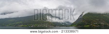 Flam is a village in Flamsdalen at the inner end of the Aurlandsfjorden a branch of Sognefjorden. The village is located in the municipality of Aurland in Sogn og Fjordane county Norway.