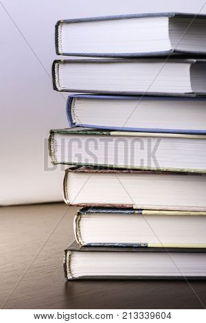 stack of old books on a table to the library.