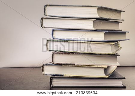 stack of old books on a table to the library.