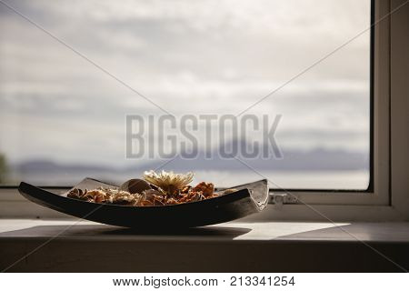 Bowl Of Pot Pourri With Landscape In The Background Lit By The Sun, Landscape Orientation