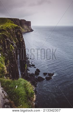 Kilt Rock And Mealt Falls, On The Eastern Coast Of The Isle Of Skye, Scotland On A Dark, Stormy Day.