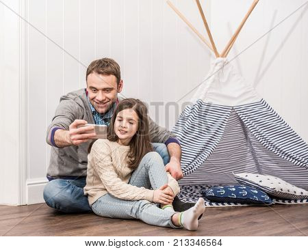 Father And Daughter Taking Selfie