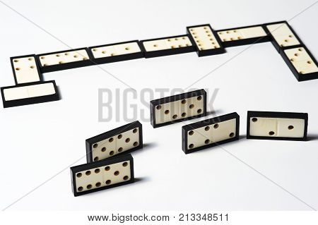 Chain of domino pieces on wnite background