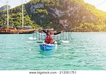 Two women are mother and daughter. Travel by boat with a kayak happy on the sea under the bright summer sky front of Ko Wua Ta lap islands 