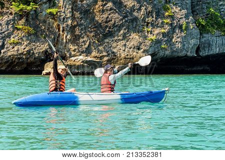 Two women are mother and daughter. Travel by boat with a kayak happy on the sea under the bright summer sky front of Ko Wua Ta lap islands 