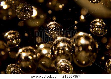 many bubbles in glass on gold background