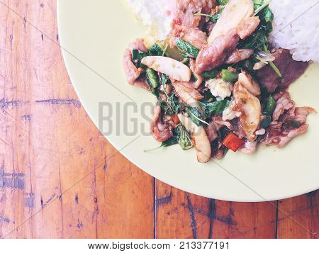 Thai Spicy Food Basil Pork Fried Rice Recipe (krapao Gai) With Fried Egg In Green Plate On Wooden Ba