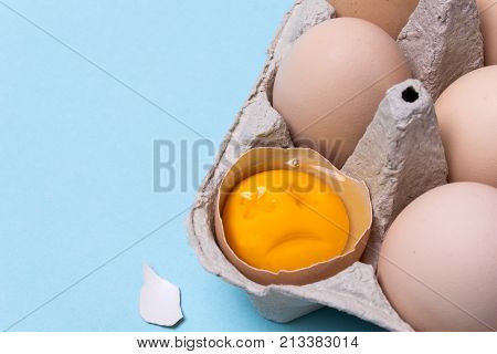 One chicken egg is broken and the yolk is sad or dead. Rotten egg. Copy space for text