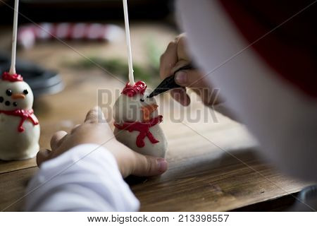 Boy making snowman popcakes