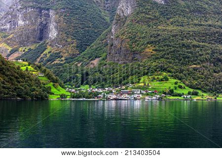 Reflection of asmall town in a norwegian fiord, Norway