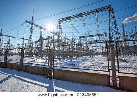 High voltage power lines in the winter. Thermal power plant. High-voltage transformer substation.