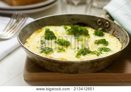 Omelette with broccoli and cheese served with bread toasts and lemonade. Selective focus.