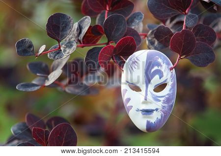 Mask on a natural background the concept we all wear masks play theater pretense