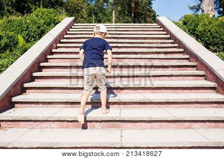 Children going up on stairs barefoot. Concept childhood image with copy space
