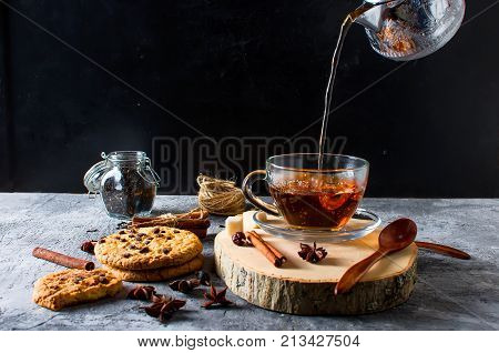 Cup Of  Tea, Biscuits, Cinnamon, Anise On Dark   Background