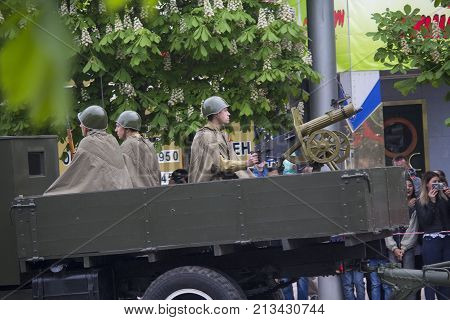 Donetsk Ukraine - May 9 2017: Reconstructors in the form of soldiers of the Red Army with a machine gun on the car at the parade in recognition of the victory in the Second World War