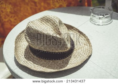 old straw hat on a table in holidays