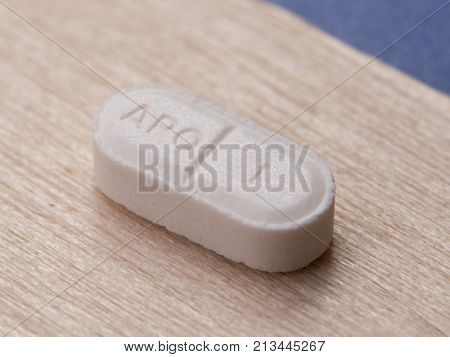 A single tablet on a wooden background