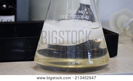 Laboratory Glass Erlenmeyer Conical Flask Filled With Chemical White Liquid For A Chemistry Experime