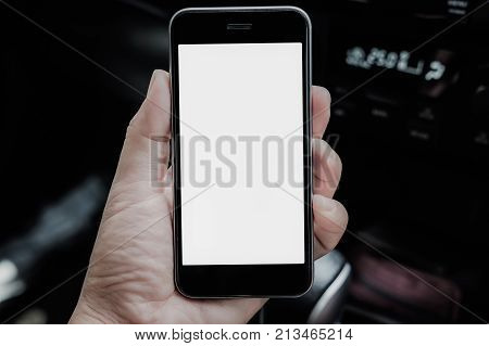 A man hand holding smart phone in car. mobile with blank screen and can be add your texts or others.