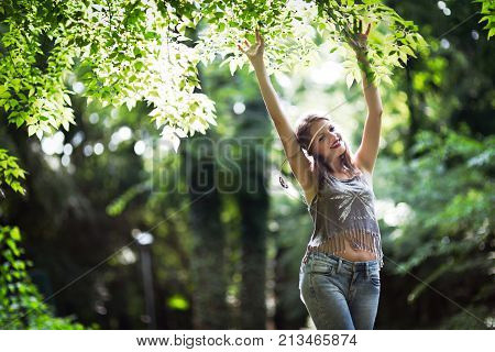 Beautiful happy woman speding time in green nature