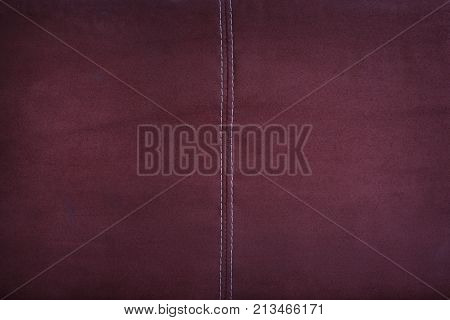 Red alcantara leather with stitching detail background