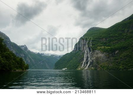 Breathtaking view of Sunnylvsfjorden fjord and famous Seven Sisters waterfalls, near Geiranger village in western Norway.