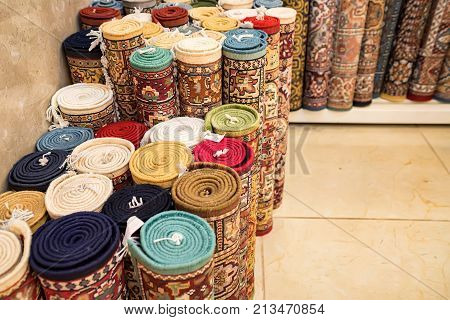Variety of colorful Persian and Indian carpets on oriental bazaar