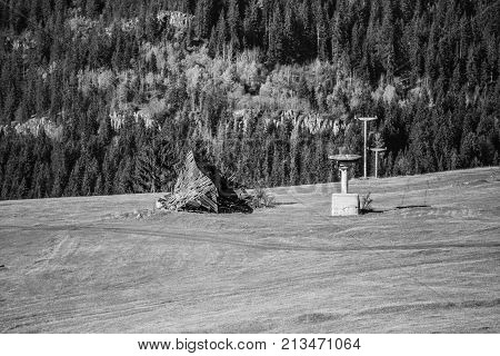 A ruined house on a mountain in black and white with a neglected zipper for winter sports