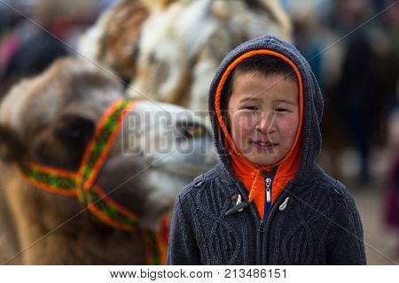 OLGIY, MONGOLIA - SEP 30, 2017: Unidentified Mongolian child during annual national competition with birds of prey 