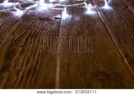 Glowing Bokeh Background With Empty Wooden Table. Christmas Background
