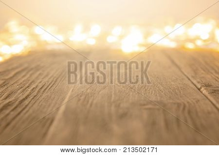Glowing Bokeh Background With Empty Wooden Table. Christmas Background