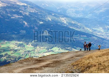 GOLDECK/ AUSTRIA - OCTOBER 8, 2017. People walking on a mountain road from the cable car station Goldeck. The Alps, Carinthia, Austria.