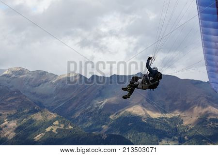Paraglider flying over the Alps mountains. Goldeck ski resort, Carinthia, Austria.