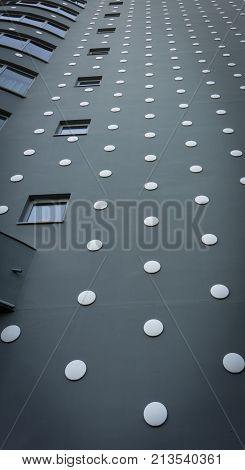 ROTTERDAM HOLLAND- AUGUST 23 2017; Low angle view unusual design modern architectural tower black extrior with white dots towers skyward from street below