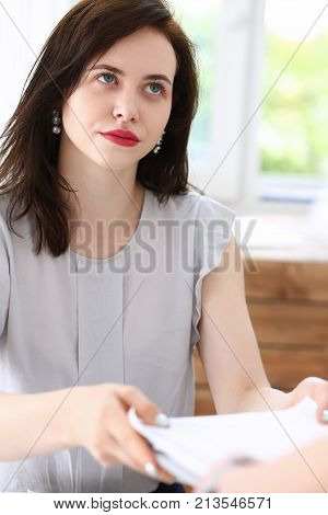 Female employee show pack of documents to busy male manager or boss give extra work to executor. White collar portrait contract approval headache and depression irs lot of new problems concept