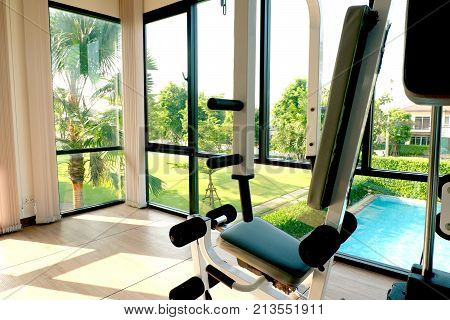 Fitness concepts idea at gym equipment at window natural view on sunny day