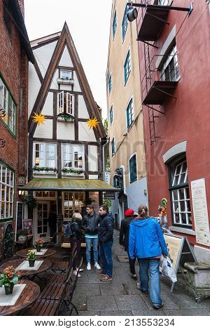 Tourists On Alley In Schnoor Quarter In Rain