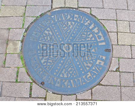 Chiba, Japan - February 26, 2017: Manhole cover of Kamagaya city in Chiba prefecture, Japan. Kamagaya city declare to non-nuclear peaceful city, so they engrave Green and Clean on their manhole cover.
