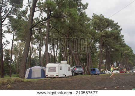 Caravan cars and tent covered. Tourists on holiday in forest setting a tent covered. Travel or sea vacations concept